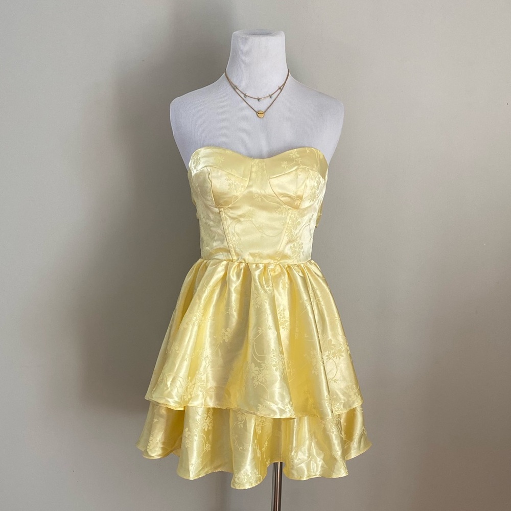 Satin yellow formal homecoming prom dress. Tiered skirt and corset with tie back